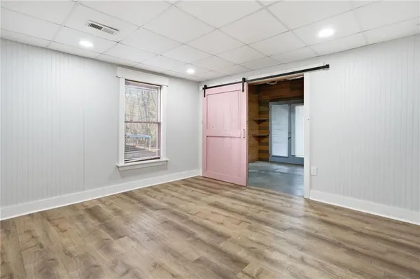 an empty room with windows and closet