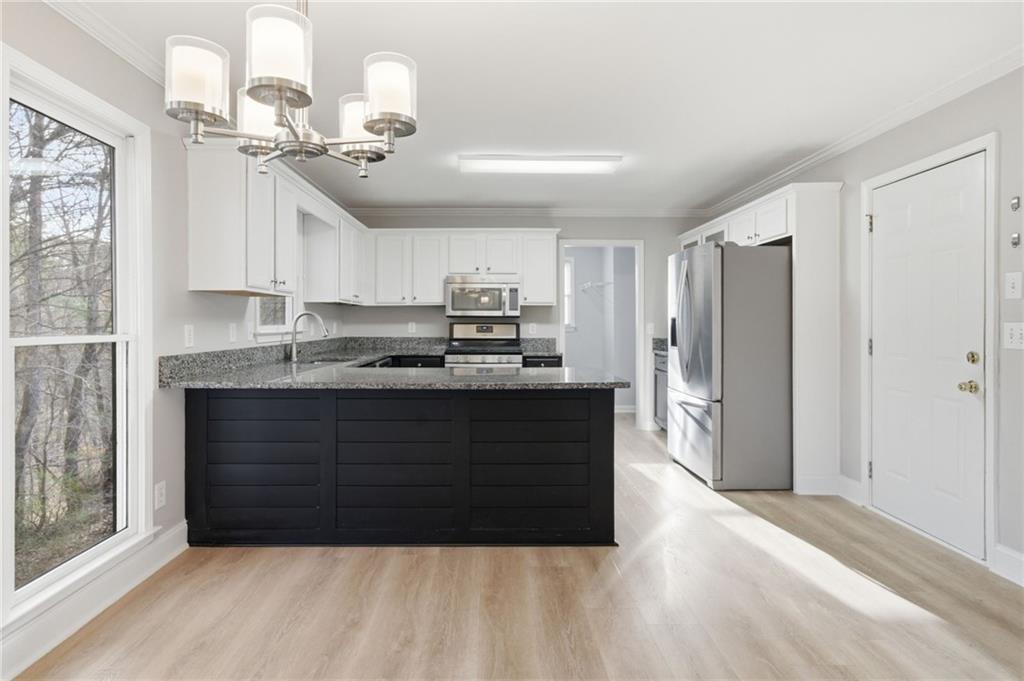 201 Arbor Hills Road North Talking Rock, GA 30175 - Photo 10 of 46 a kitchen with kitchen island granite countertop a refrigerator cabinets and wooden floor