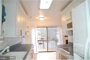 2335 Millennium Lane Reston, VA 20191 - Photo 5 of 18 a kitchen with granite countertop a sink and a refrigerator