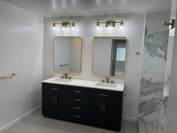 a bathroom with a double vanity sink and a mirror
