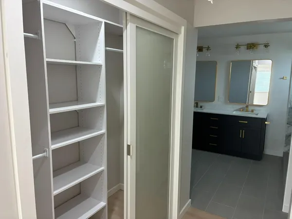 a bathroom with a double vanity sink and a mirror