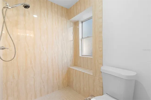 a bathroom with a shower curtain and a toilet