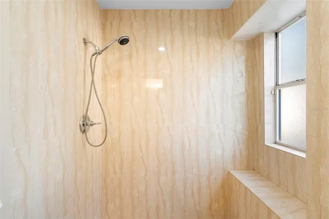 a bathroom with a shower curtain and a window