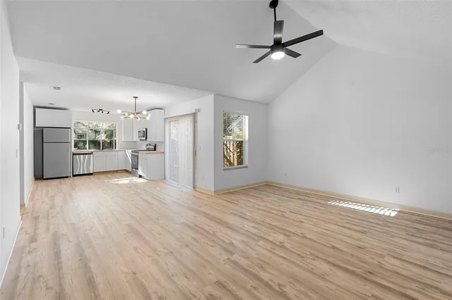 a view of a kitchen with a sink and a refrigerator
