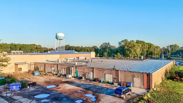 a view of multiple houses with city street and lake view