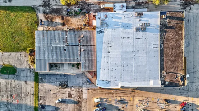 an aerial view of a brick building with large windows