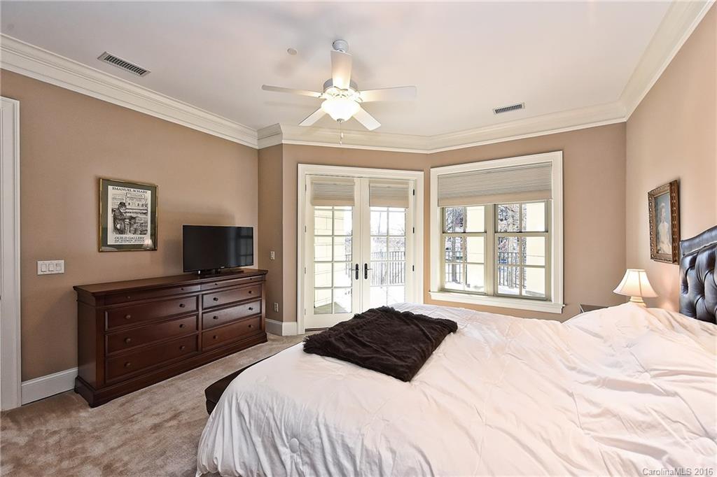 2823 Providence Road, Unit 228 Charlotte, NC 28211 - Photo 14 of 24 a bedroom with a large bed and a flat tv screen on dresser