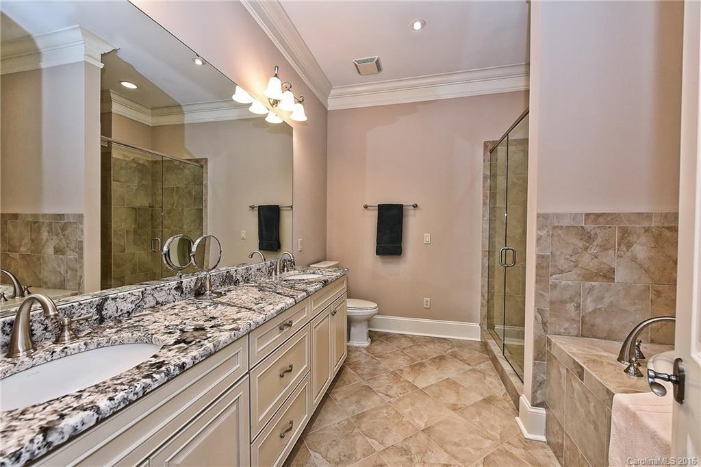2823 Providence Road, Unit 228 Charlotte, NC 28211 - Photo 15 of 24 a spacious bathroom with a granite countertop sink a mirror and a shower