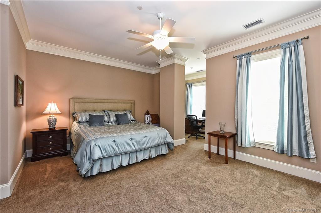 2823 Providence Road, Unit 228 Charlotte, NC 28211 - Photo 17 of 24 a bedroom with a bed and a chandelier