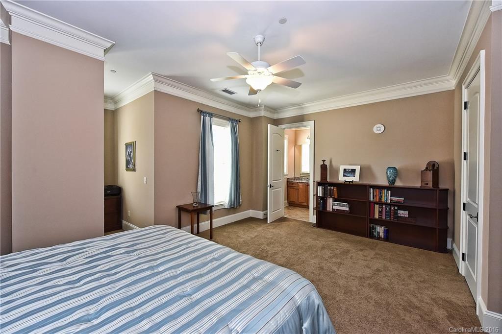 2823 Providence Road, Unit 228 Charlotte, NC 28211 - Photo 18 of 24 a bedroom with a bed and a chandelier