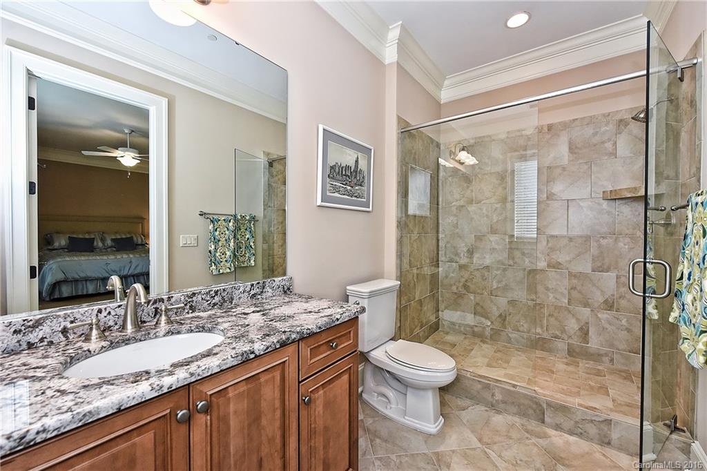 2823 Providence Road, Unit 228 Charlotte, NC 28211 - Photo 20 of 24 a bathroom with a granite countertop sink toilet and shower