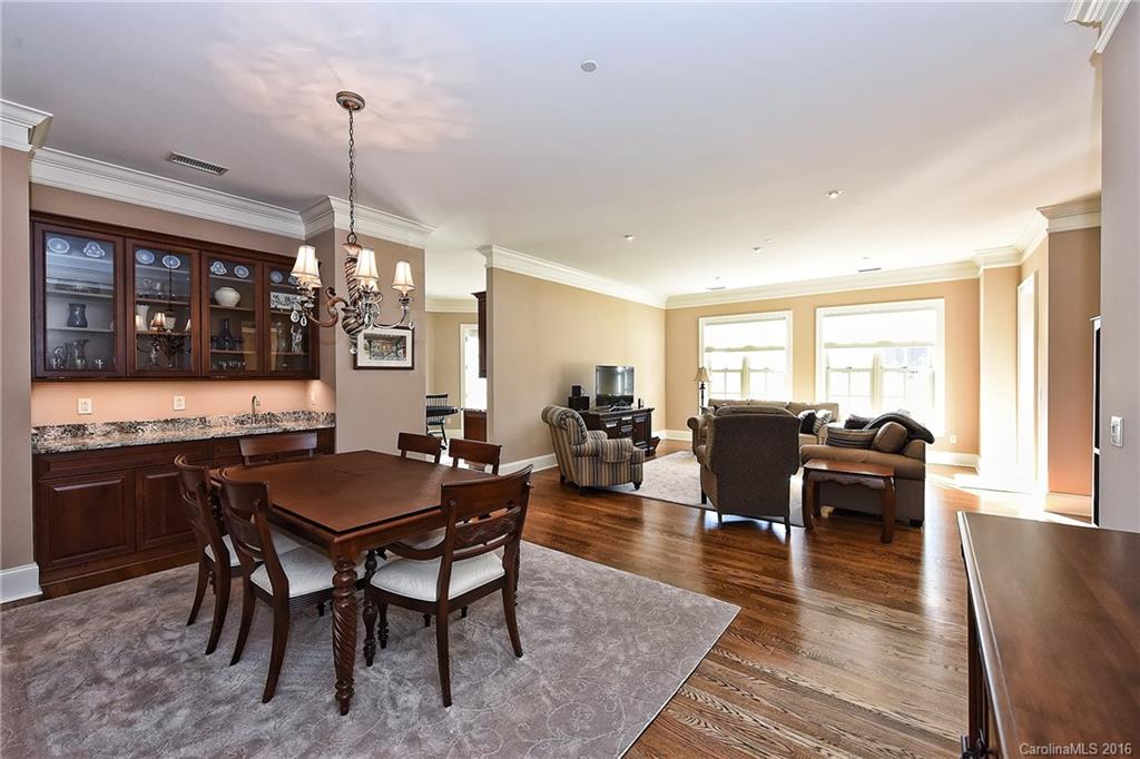 2823 Providence Road, Unit 228 Charlotte, NC 28211 - Photo 5 of 24 a view of a dining room and livingroom with furniture wooden floor a chandelier