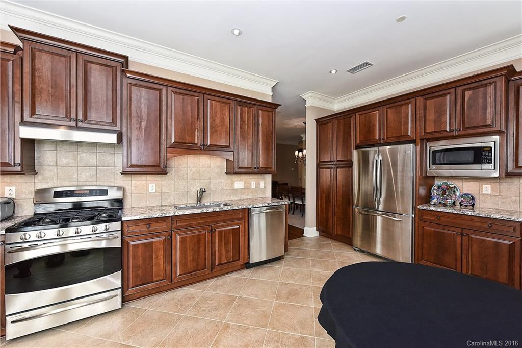 2823 Providence Road, Unit 228 Charlotte, NC 28211 - Photo 10 of 24 a kitchen with stainless steel appliances granite countertop a stove refrigerator sink and cabinets