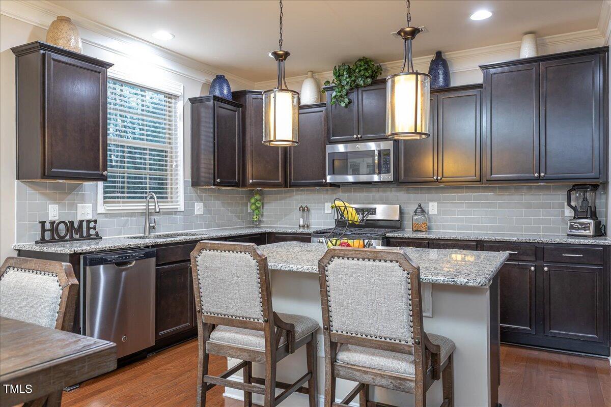 7656 Channery Way Raleigh, NC 27616 - Photo 13 of 44 Kitchen with island and granite countertops