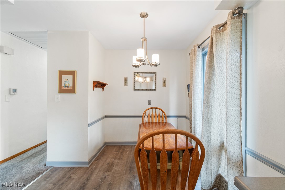 1067 Munroe Falls Kent Road Kent, OH 44240 - Photo 12 of 31 Dining area featuring hardwood / wood-style flooring and a notable chandelier