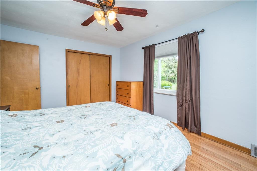 349 Thompson Run Road Pittsburgh, PA 15237 - Photo 11 of 22 a bedroom with a bed and a chandelier