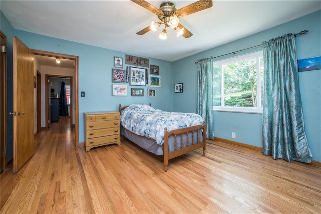 349 Thompson Run Road Pittsburgh, PA 15237 - Photo 12 of 22 a bedroom with a bed and a chandelier