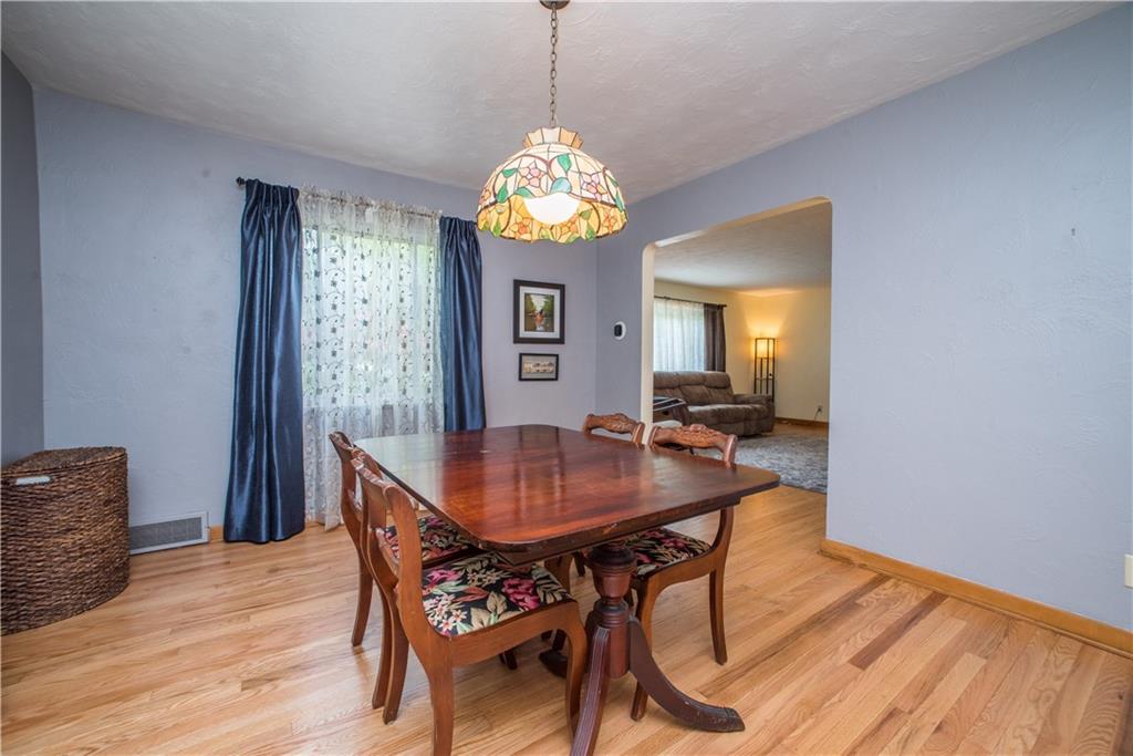 349 Thompson Run Road Pittsburgh, PA 15237 - Photo 5 of 22 a dining room with furniture a chandelier and wooden floor
