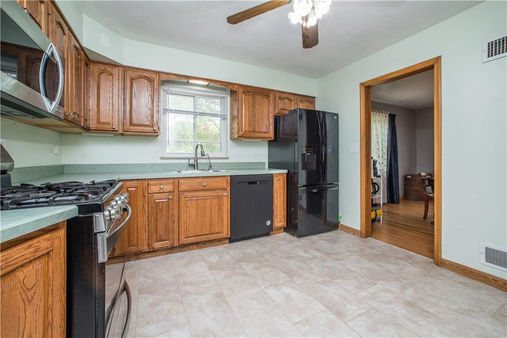 349 Thompson Run Road Pittsburgh, PA 15237 - Photo 6 of 22 a kitchen with stainless steel appliances granite countertop a stove top oven a refrigerator and dishwasher