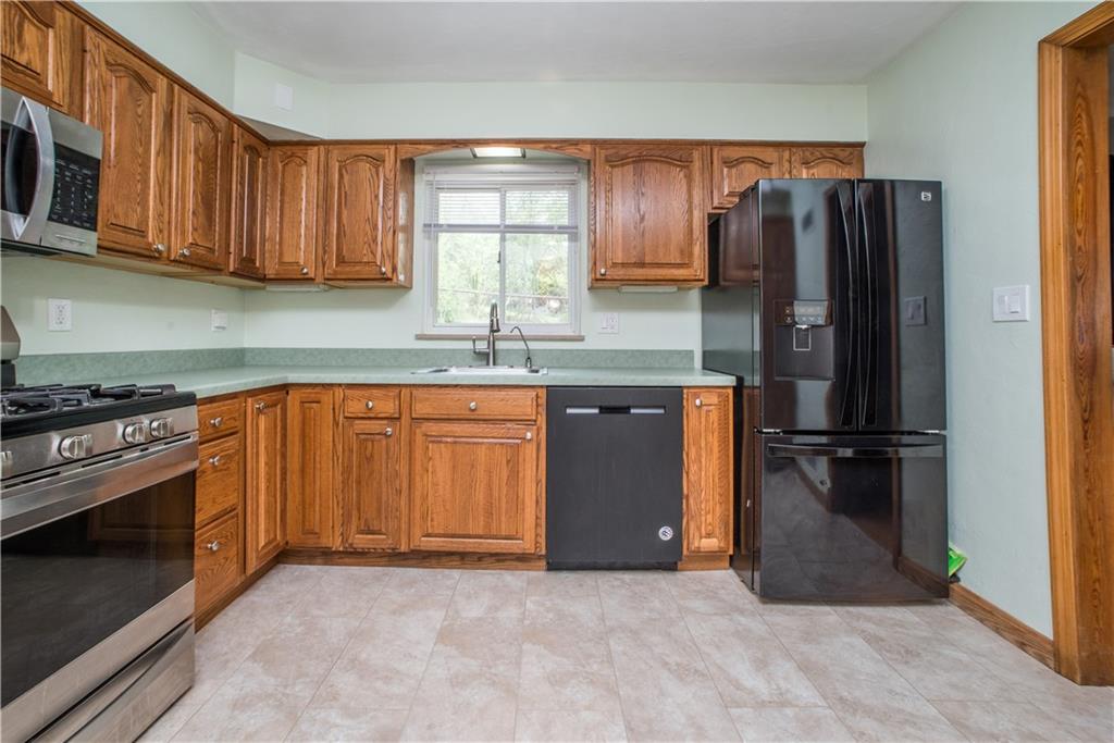 349 Thompson Run Road Pittsburgh, PA 15237 - Photo 7 of 22 a kitchen with stainless steel appliances granite countertop a refrigerator stove and microwave