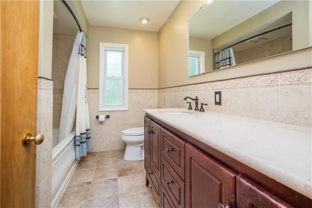 349 Thompson Run Road Pittsburgh, PA 15237 - Photo 10 of 22 a bathroom with a sink a toilet and a mirror