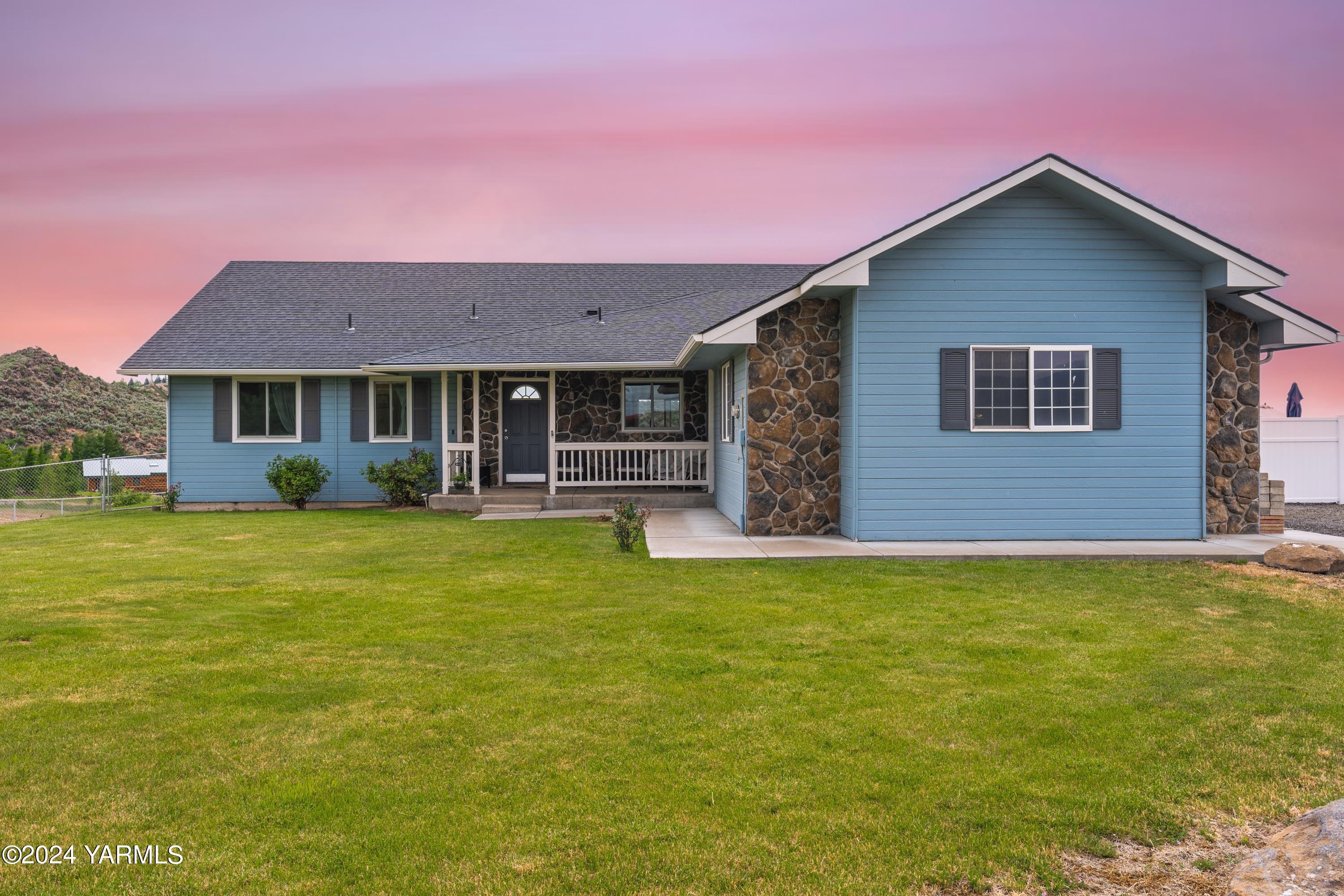 a front view of house with yard and green space