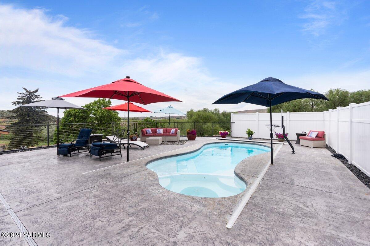 1084 Thompson Road Cowiche, WA 98923 - Photo 15 of 21 a view of a swimming pool with chairs in patio