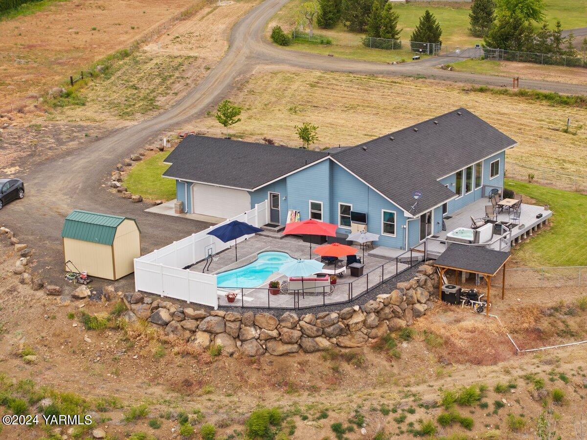 1084 Thompson Road Cowiche, WA 98923 - Photo 2 of 21 a aerial view of a house with table and chairs