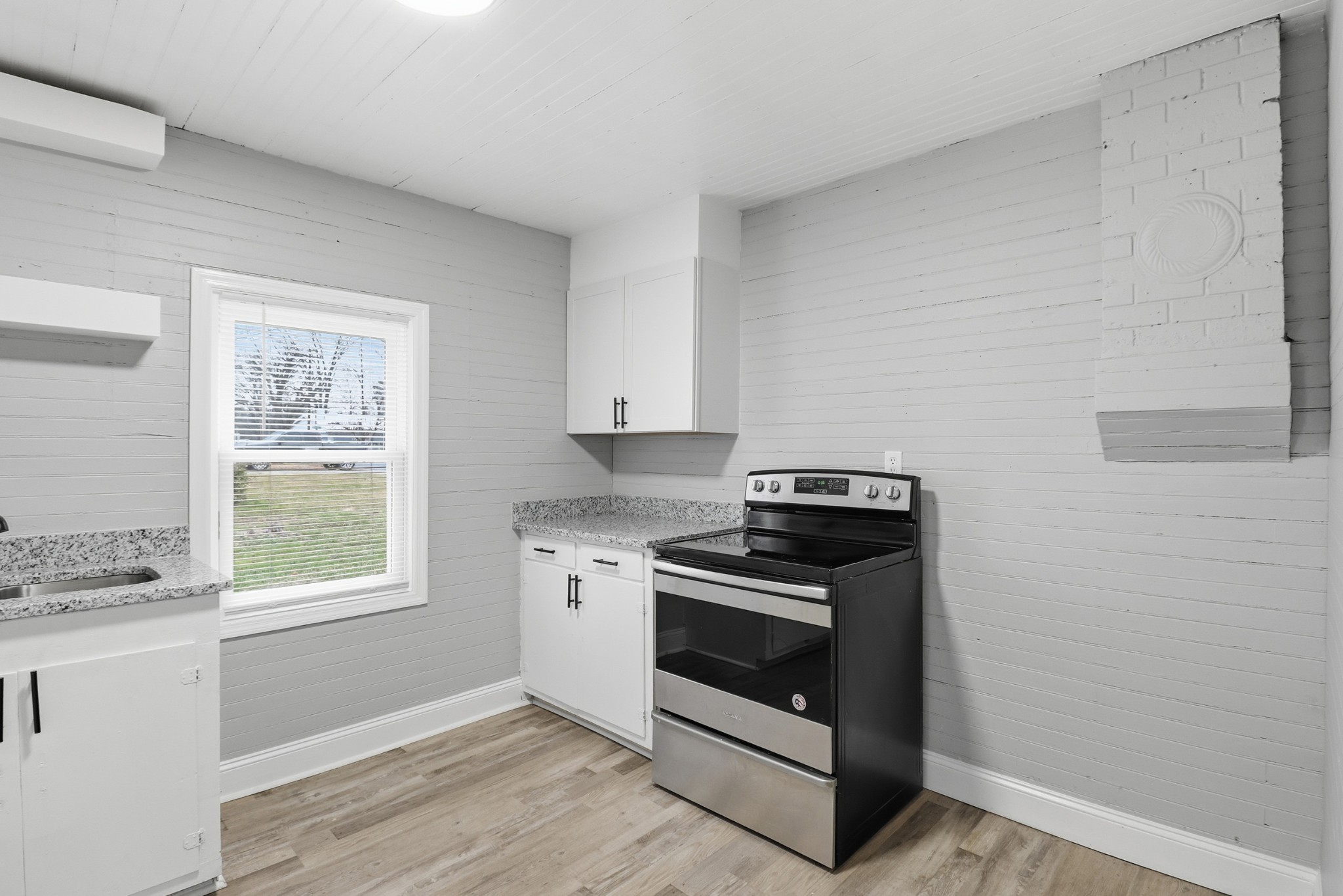 612 Maple Street Manchester, TN 37355 - Photo 14 of 20 a kitchen with a stove and a window