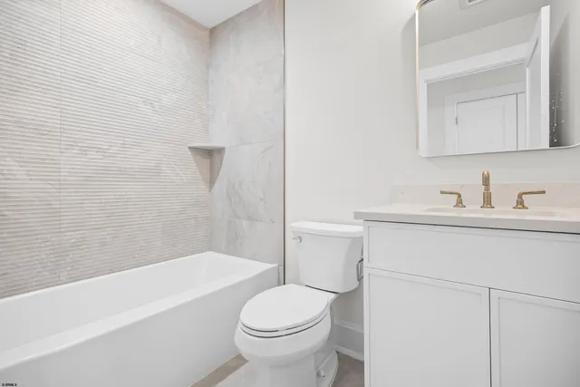 a bathroom with a sink toilet and bathtub