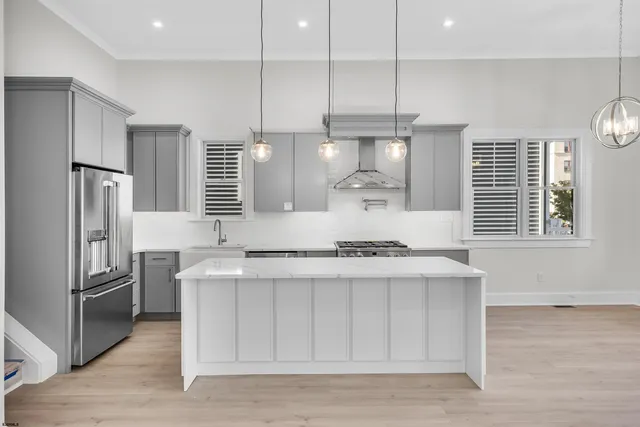 a kitchen with stainless steel appliances granite countertop a sink a stove and a refrigerator