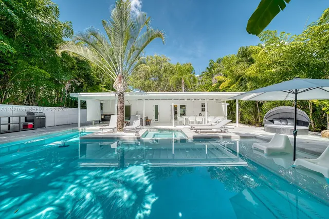 a view of house with swimming pool outdoor seating