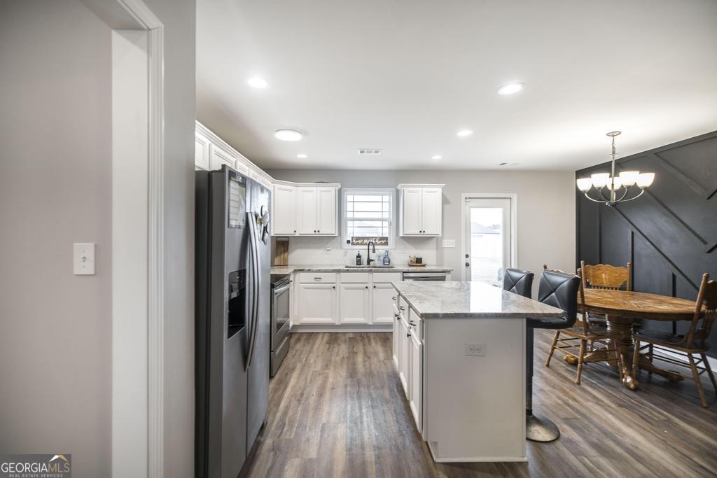 137 Sadie Heights Boulevard Perry, GA 31069 - Photo 12 of 25 a kitchen with white cabinets and stainless steel appliances