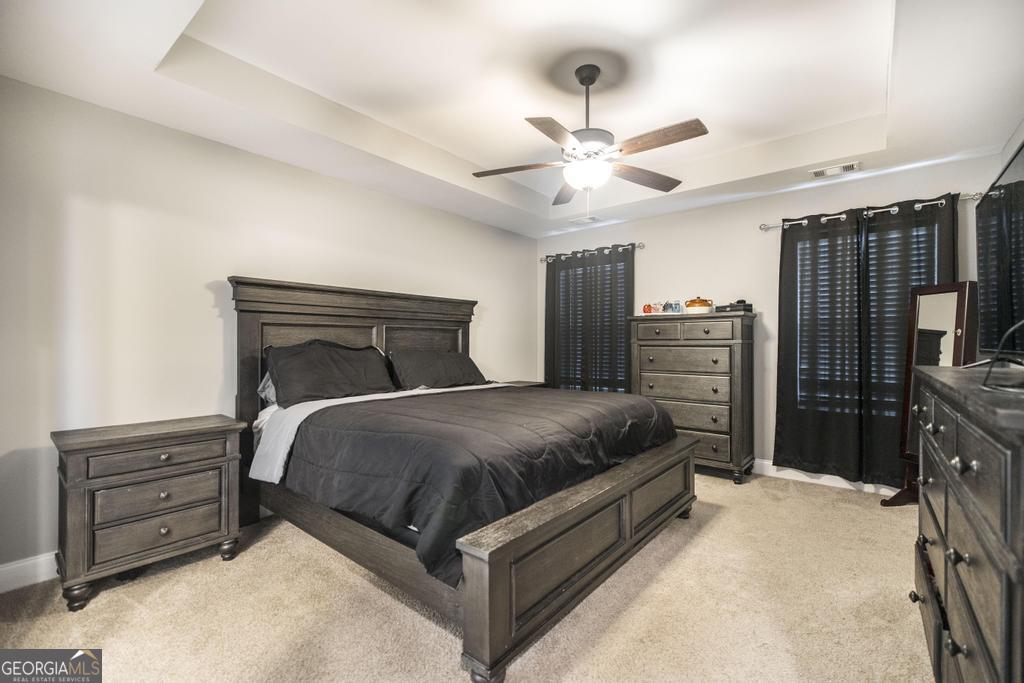 137 Sadie Heights Boulevard Perry, GA 31069 - Photo 14 of 25 a bedroom with a bed and dresser