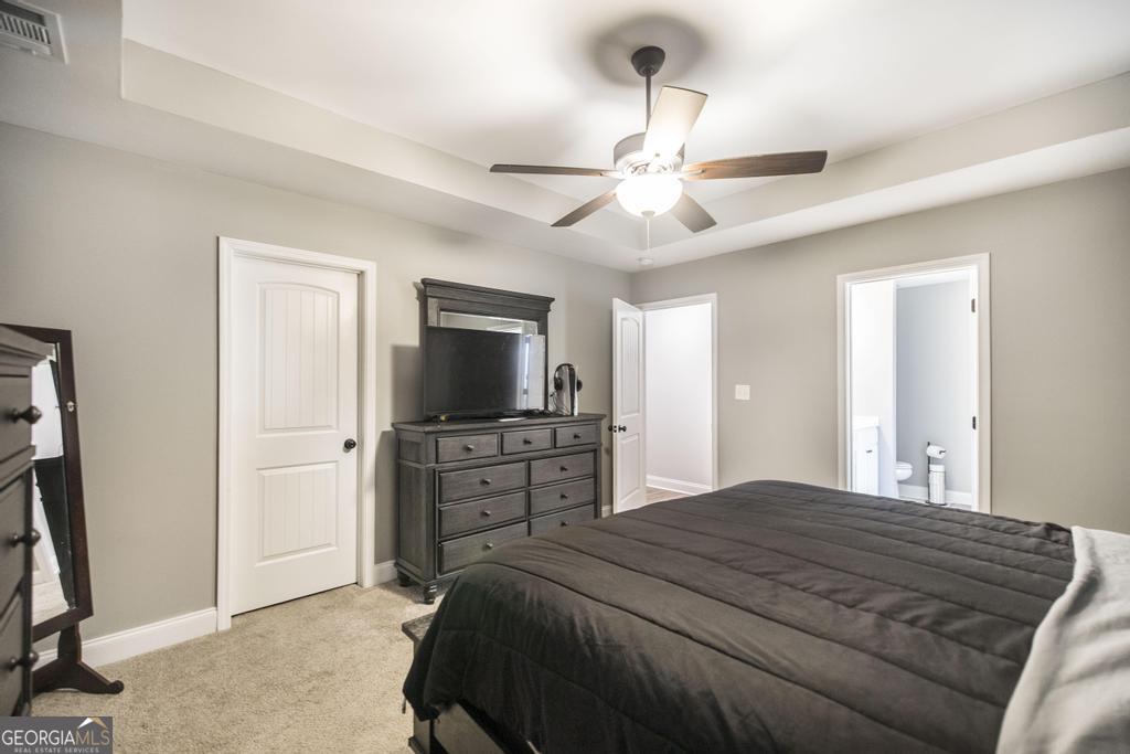 137 Sadie Heights Boulevard Perry, GA 31069 - Photo 15 of 25 a bedroom with a bed and a flat tv screen on dresser