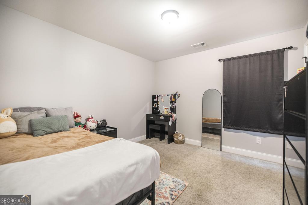 137 Sadie Heights Boulevard Perry, GA 31069 - Photo 20 of 25 a bedroom with a bed and a dresser
