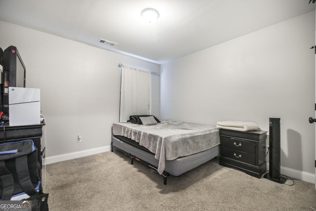137 Sadie Heights Boulevard Perry, GA 31069 - Photo 23 of 25 a bedroom with a bed and a tv