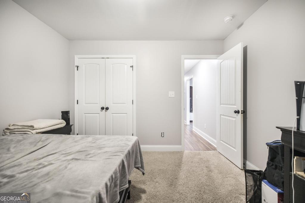 137 Sadie Heights Boulevard Perry, GA 31069 - Photo 24 of 25 a bedroom with a bed and a hallway
