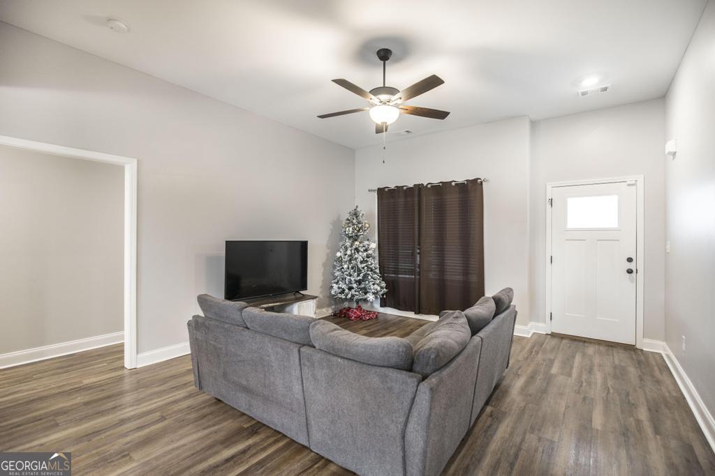 137 Sadie Heights Boulevard Perry, GA 31069 - Photo 5 of 25 a living room with furniture and a flat screen tv