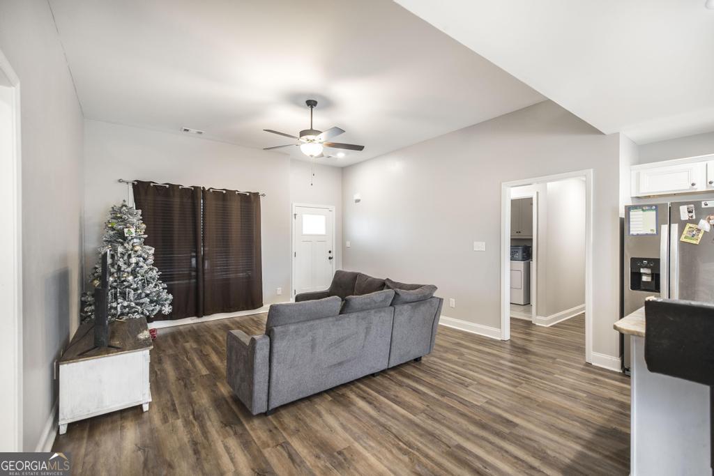 137 Sadie Heights Boulevard Perry, GA 31069 - Photo 6 of 25 a living room with furniture and a chandelier