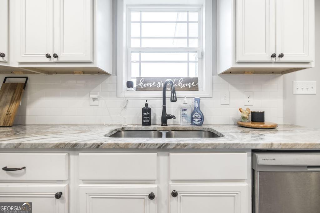 137 Sadie Heights Boulevard Perry, GA 31069 - Photo 10 of 25 a kitchen with granite countertop white cabinets and a window