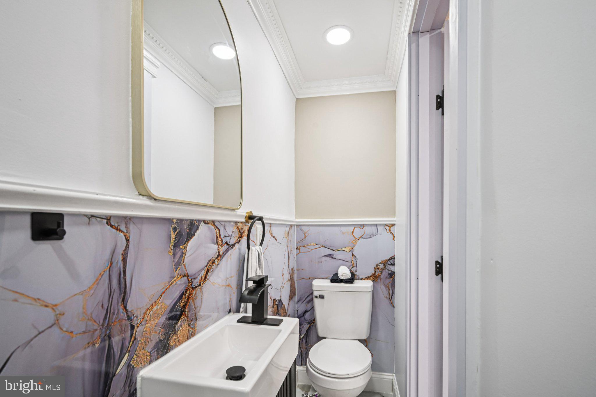 5702 Belmar Street Philadelphia, PA 19143 - Photo 14 of 29 a bathroom with a toilet a sink and a mirror
