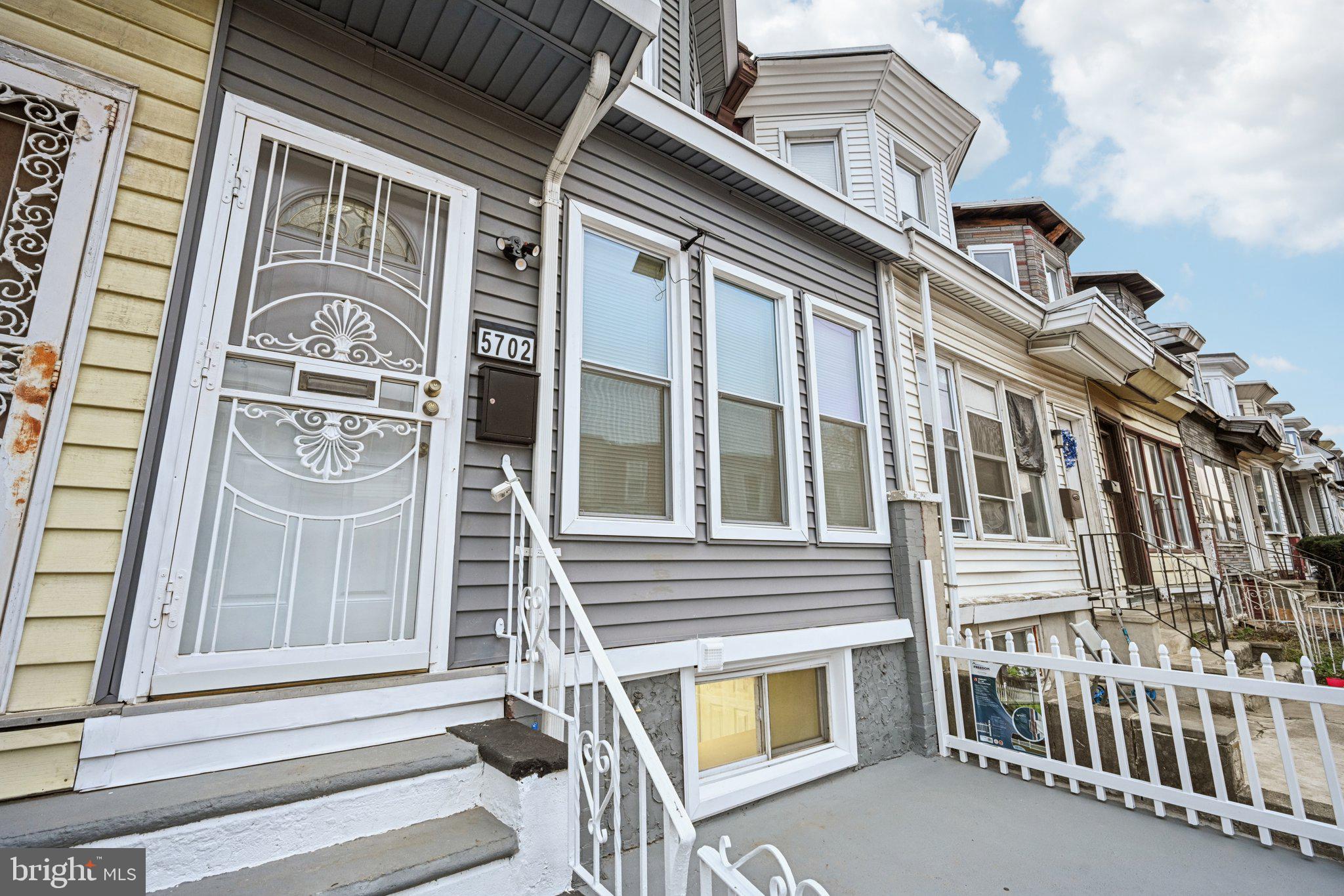 5702 Belmar Street Philadelphia, PA 19143 - Photo 2 of 29 a front view of a house with a large windows