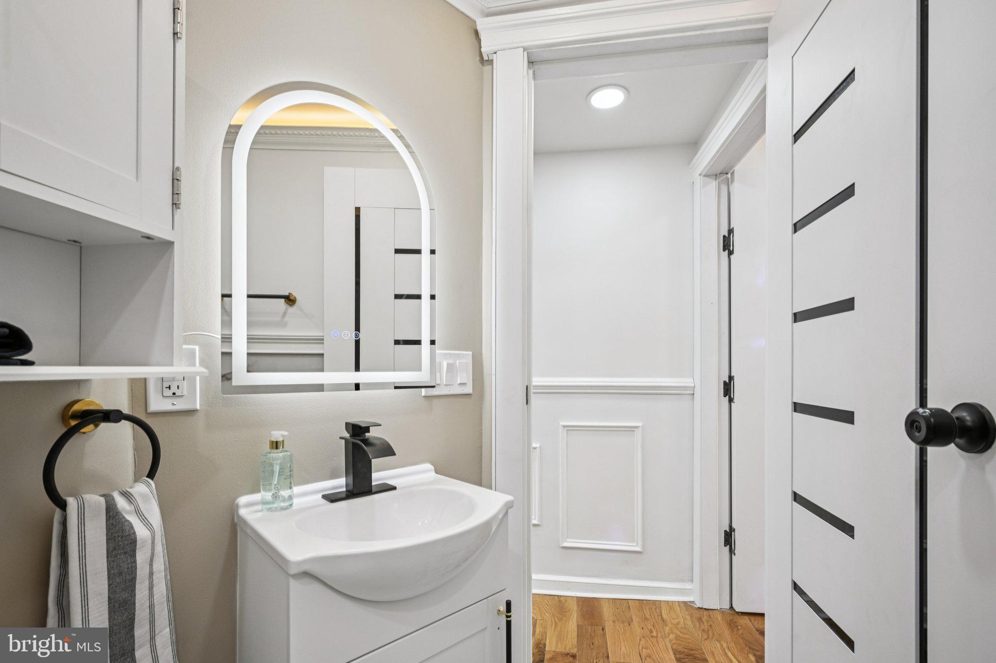 5702 Belmar Street Philadelphia, PA 19143 - Photo 21 of 29 a bathroom with a sink a toilet and a mirror