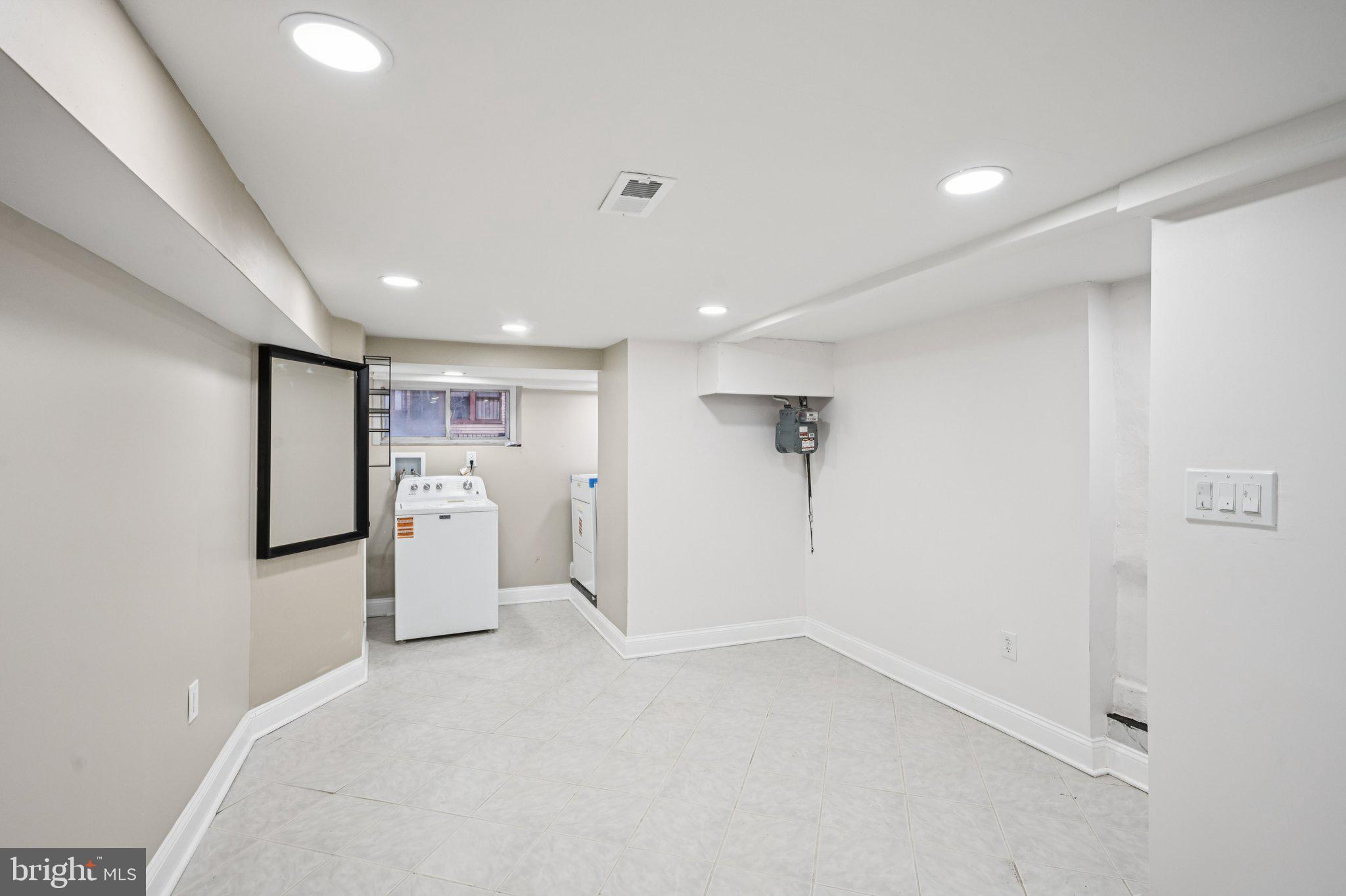 5702 Belmar Street Philadelphia, PA 19143 - Photo 23 of 29 a view of a kitchen with a refrigerator and a window
