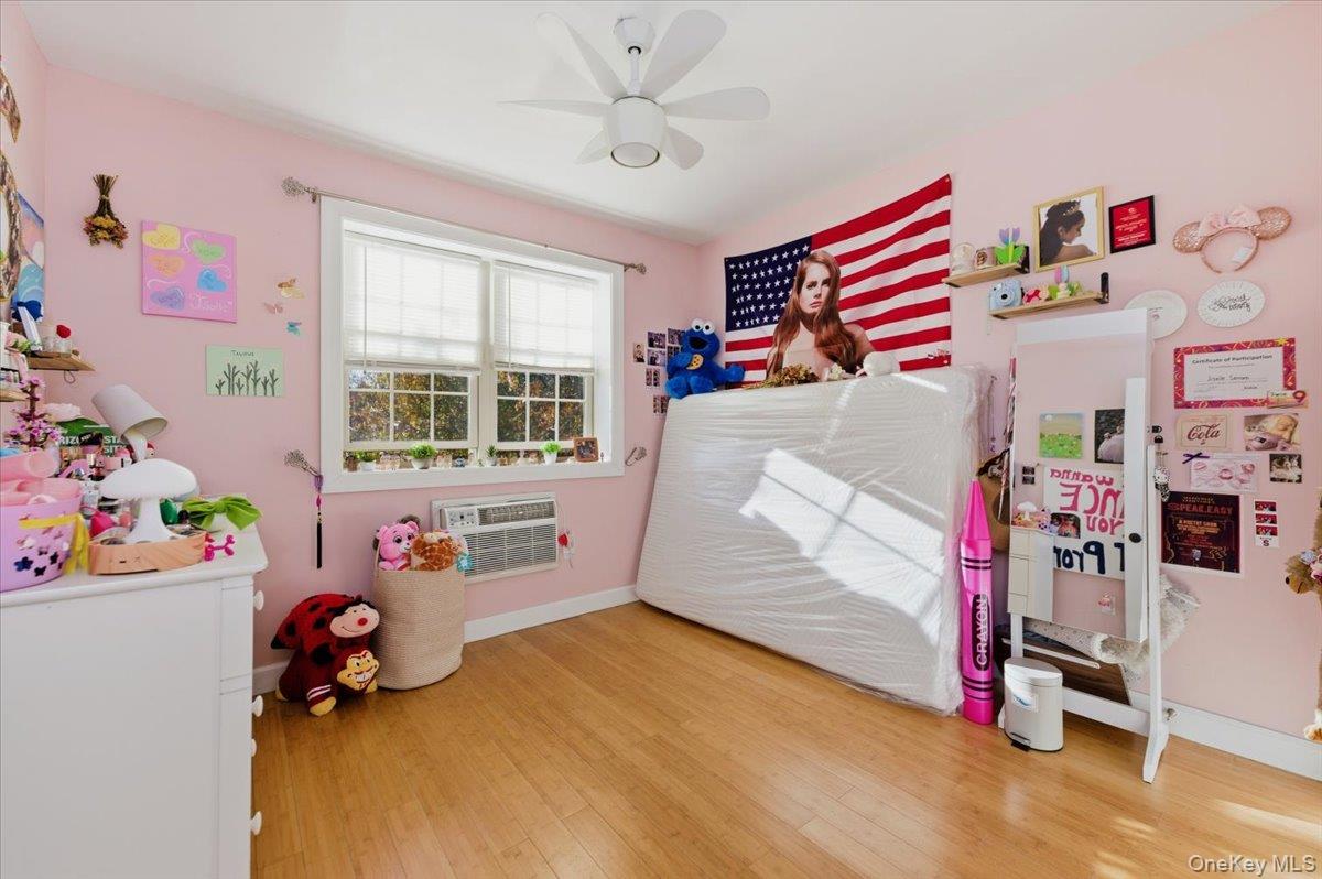 2853 Ely Avenue, Unit 3 Bronx, NY 10469 - Photo 12 of 20 a bedroom with toys and a chandelier