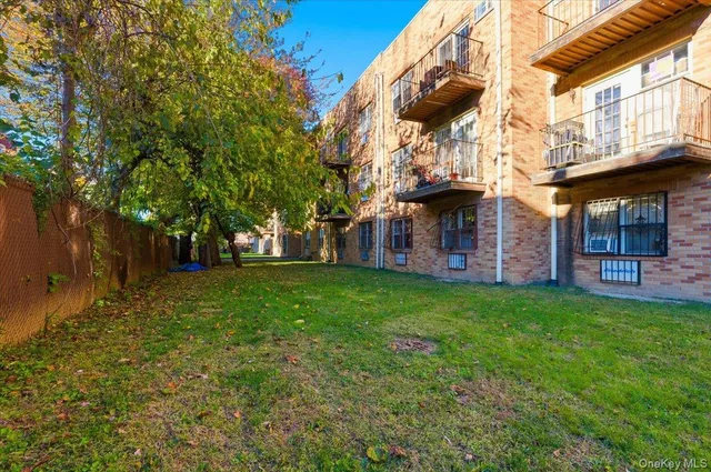 a front view of a building with a garden