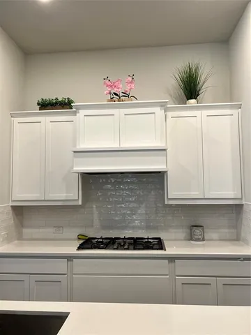 a view of a room with wooden floor and white walls