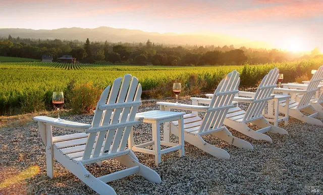 a view of a chairs and table on wooden deck