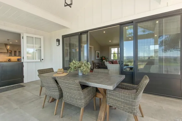 a view of a dining room with furniture and a potted plant